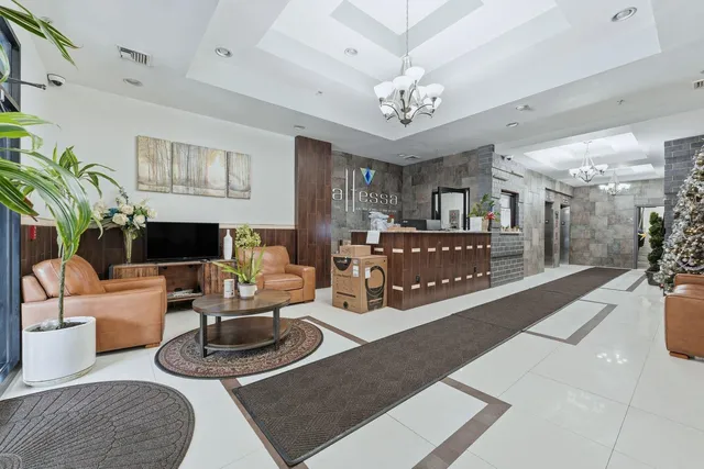 a living room with furniture a chandelier a fireplace and a chandelier