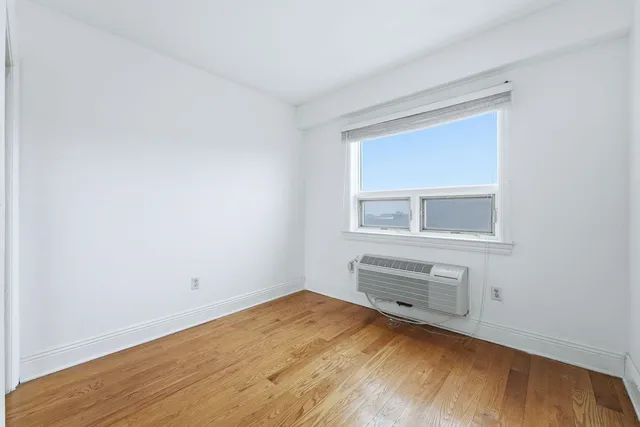 a room with a wooden floor and closet