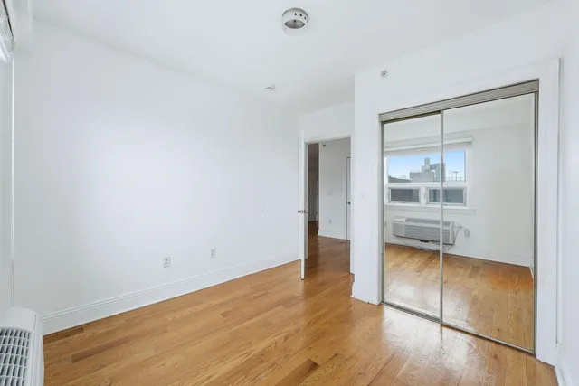 a view of wooden floor and a cabinet in a room