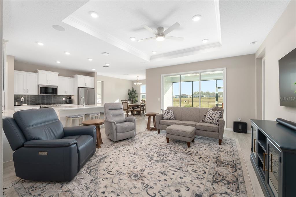10049 Southwest 107th Lane Ocala, FL 34481 - Photo 15 of 67 a living room with furniture and a flat screen tv