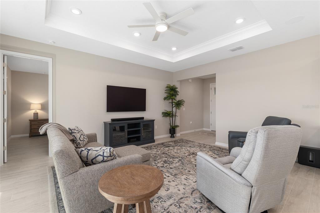 10049 Southwest 107th Lane Ocala, FL 34481 - Photo 17 of 67 a living room with furniture and a flat screen tv