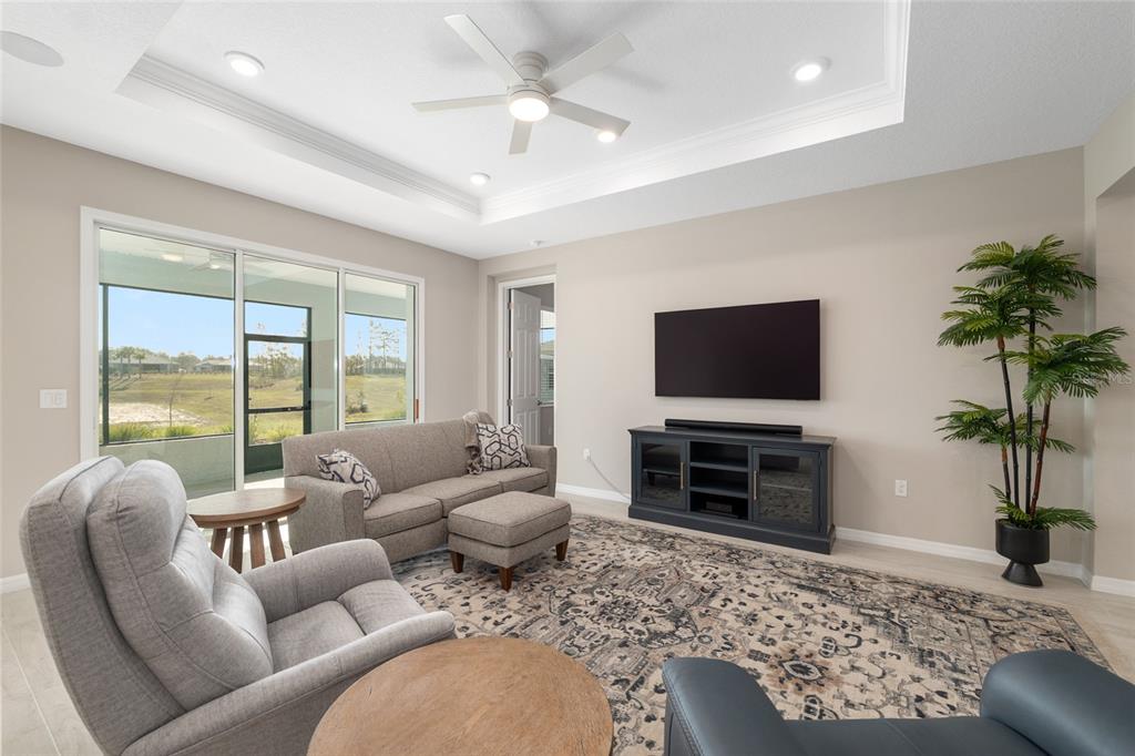10049 Southwest 107th Lane Ocala, FL 34481 - Photo 18 of 67 a living room with furniture and a flat screen tv