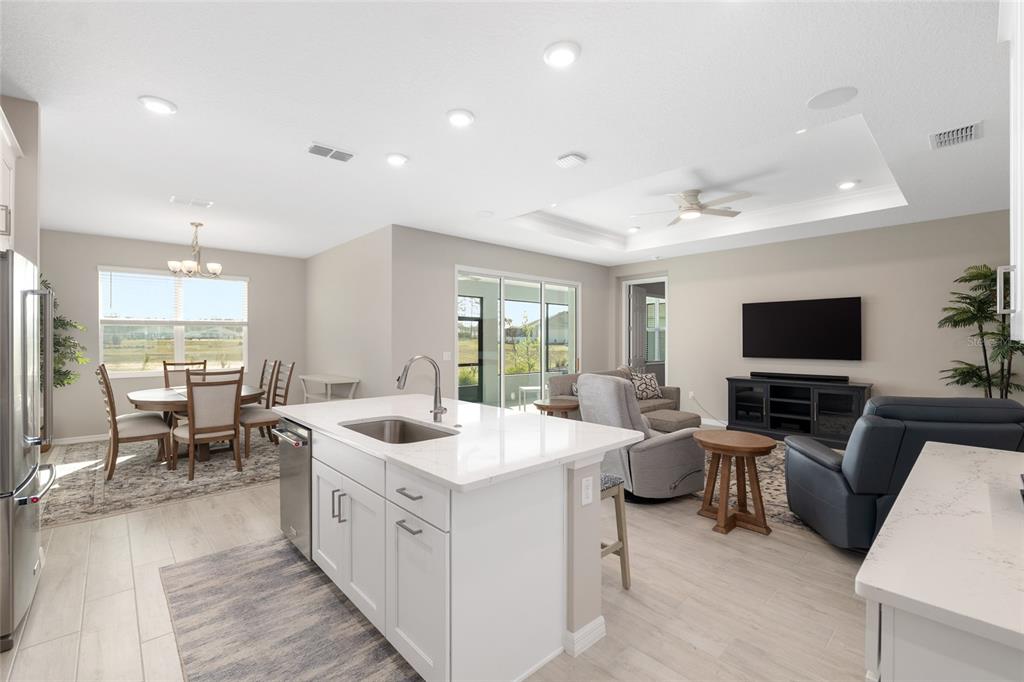10049 Southwest 107th Lane Ocala, FL 34481 - Photo 28 of 67 a large white dining hall with stainless steel appliances granite countertop a sink and a large window
