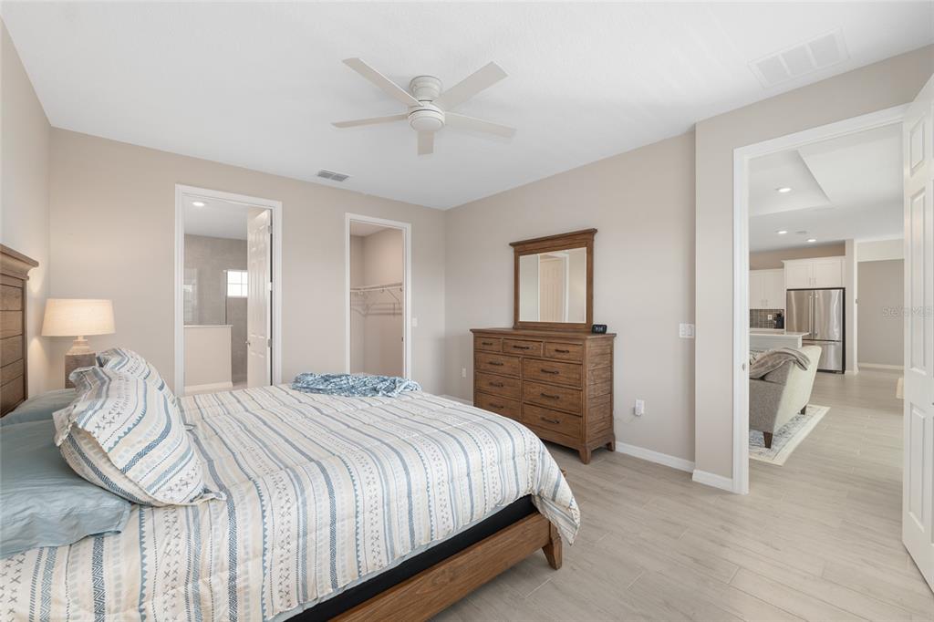 10049 Southwest 107th Lane Ocala, FL 34481 - Photo 34 of 67 a bedroom with a bed and a chandelier