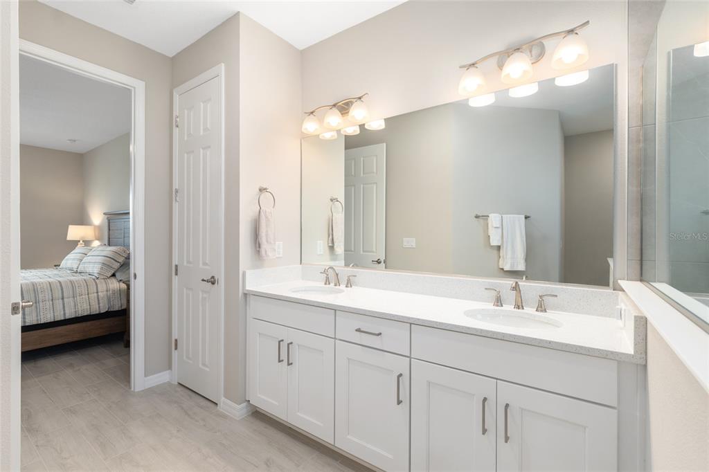 10049 Southwest 107th Lane Ocala, FL 34481 - Photo 37 of 67 a bathroom with double vanity and a mirror