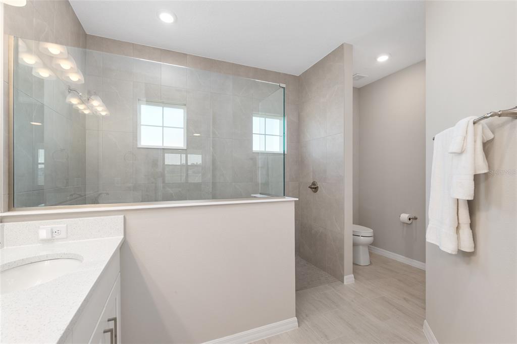 10049 Southwest 107th Lane Ocala, FL 34481 - Photo 38 of 67 a bathroom with a sink a toilet and shower