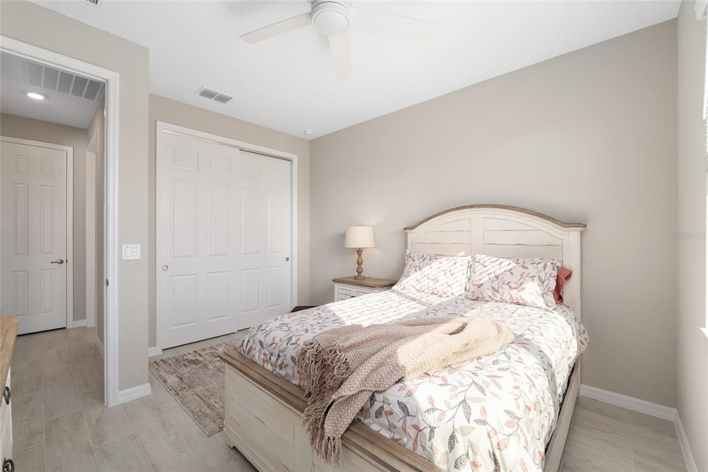 10049 Southwest 107th Lane Ocala, FL 34481 - Photo 42 of 67 a bedroom with a bed and a mirror