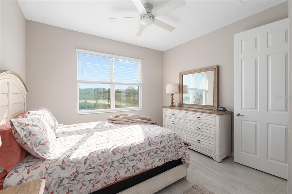 10049 Southwest 107th Lane Ocala, FL 34481 - Photo 43 of 67 a spacious bedroom with a bed and a dresser