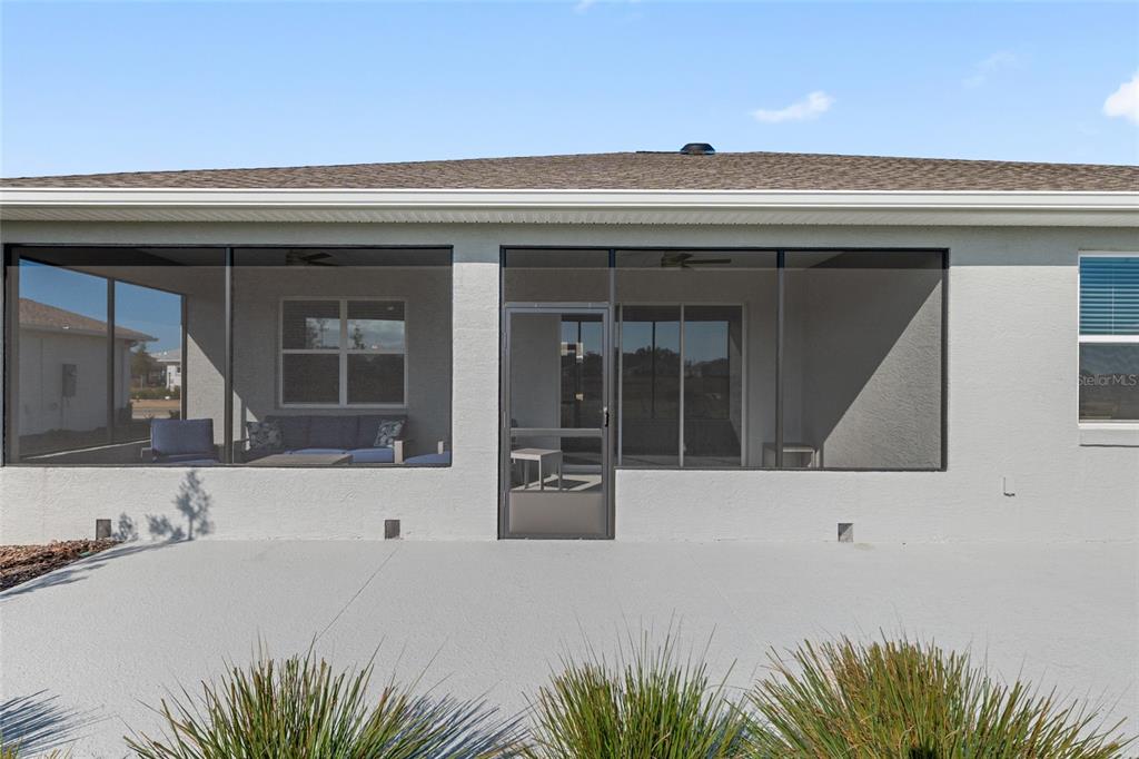 10049 Southwest 107th Lane Ocala, FL 34481 - Photo 59 of 67 a front view of a house with a outdoor space