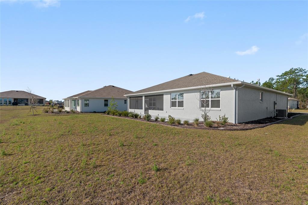10049 Southwest 107th Lane Ocala, FL 34481 - Photo 66 of 67 a view of a house with backyard and garden