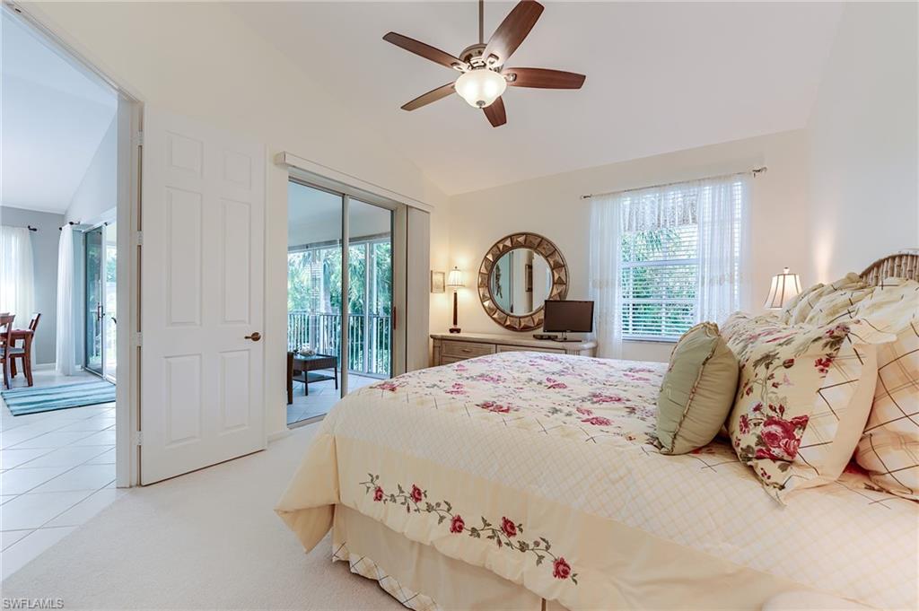 23166 Rosedale Drive, Unit 201 Estero, FL 34135 - Photo 14 of 40 a bedroom with a large bed and a window