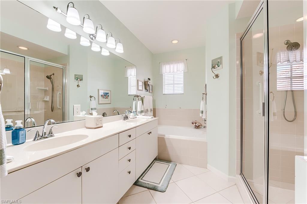 23166 Rosedale Drive, Unit 201 Estero, FL 34135 - Photo 17 of 40 a spacious bathroom with a double vanity sink mirror and bathtub