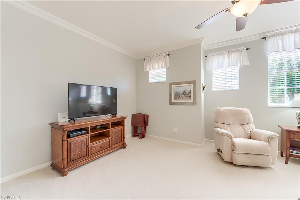 23166 Rosedale Drive, Unit 201 Estero, FL 34135 - Photo 18 of 40 a living room with furniture and a flat screen tv