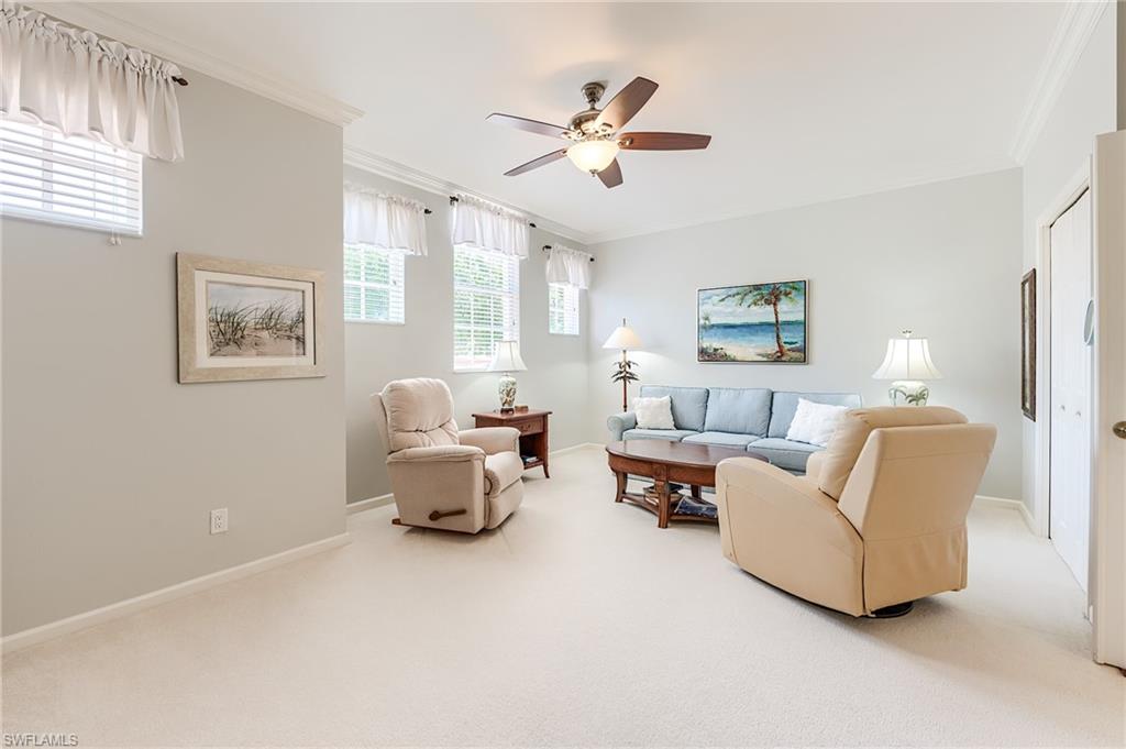 23166 Rosedale Drive, Unit 201 Estero, FL 34135 - Photo 19 of 40 a living room with furniture and a large window