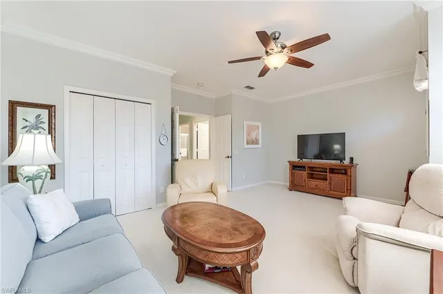 a living room with furniture a ceiling fan and a rug