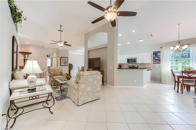 a living room with furniture and kitchen view