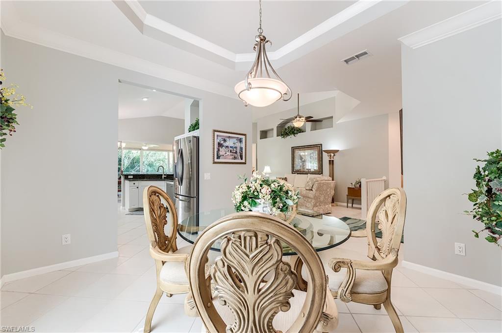 23166 Rosedale Drive, Unit 201 Estero, FL 34135 - Photo 27 of 40 a view of a dining room with furniture window and wooden floor