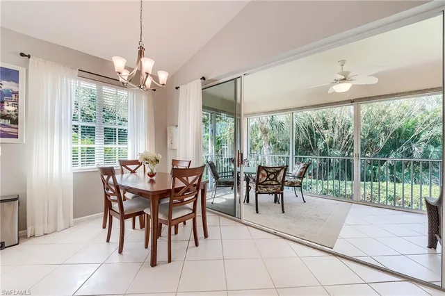 a view of a dining room with furniture large windows and outside view