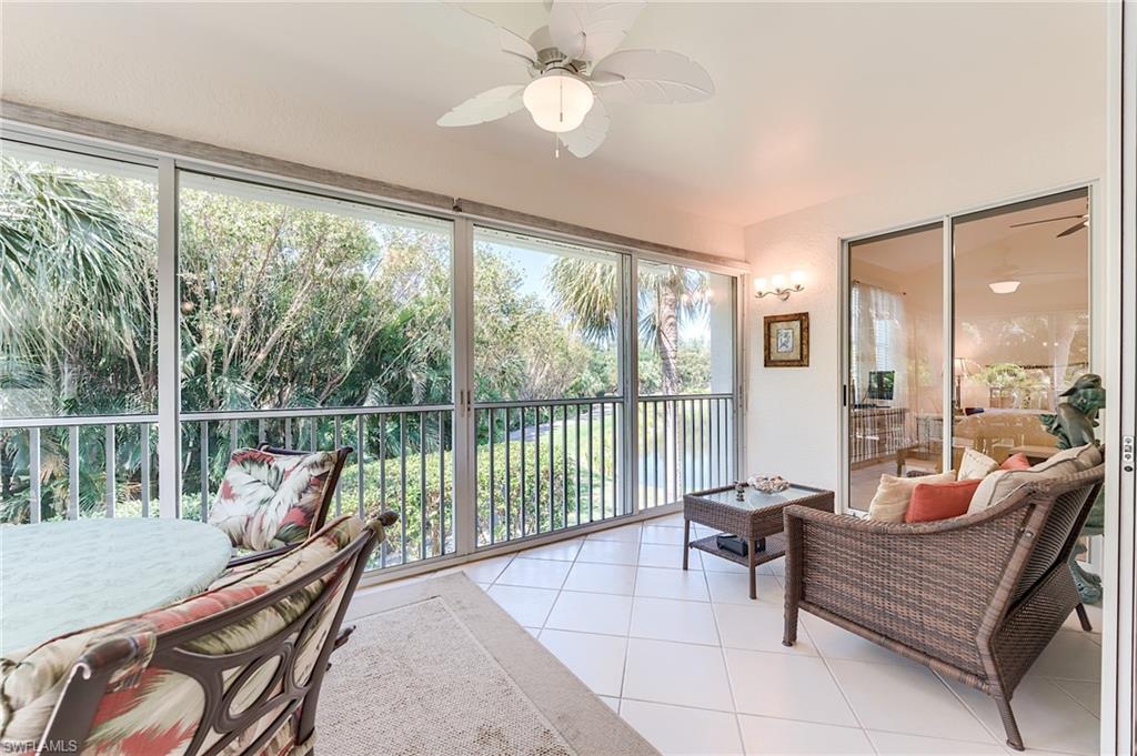 23166 Rosedale Drive, Unit 201 Estero, FL 34135 - Photo 29 of 40 a living room with furniture and a floor to ceiling window