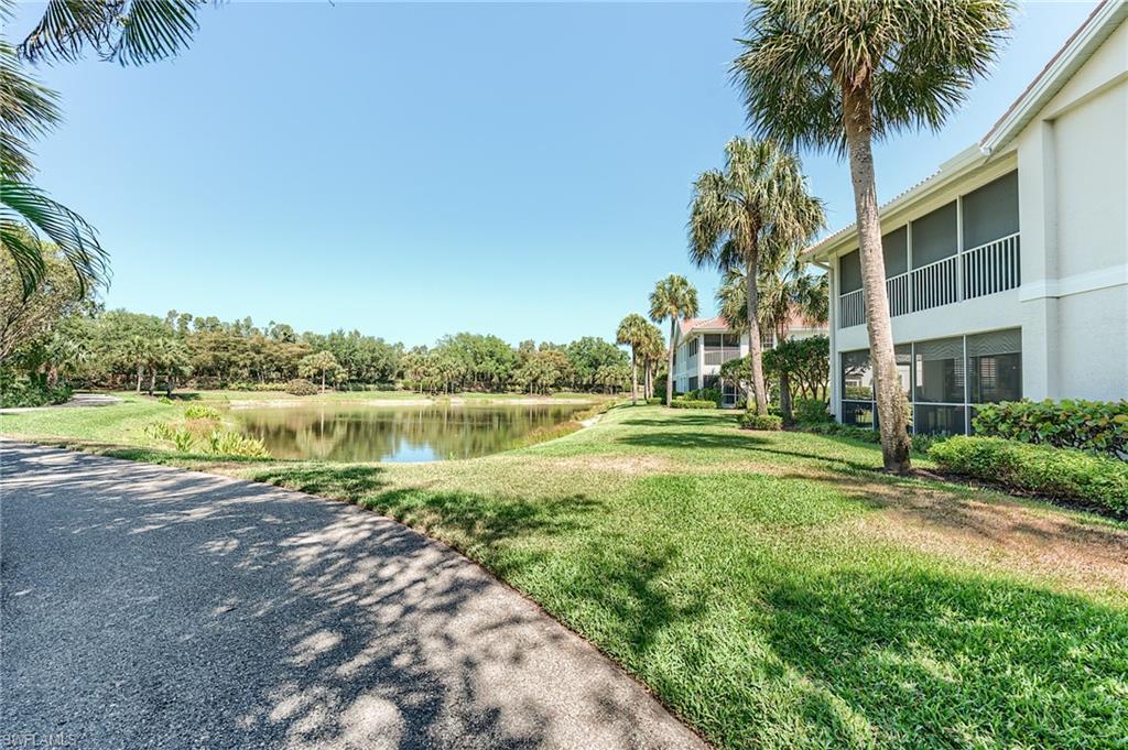 23166 Rosedale Drive, Unit 201 Estero, FL 34135 - Photo 38 of 40 a view of a lake with a building in the background
