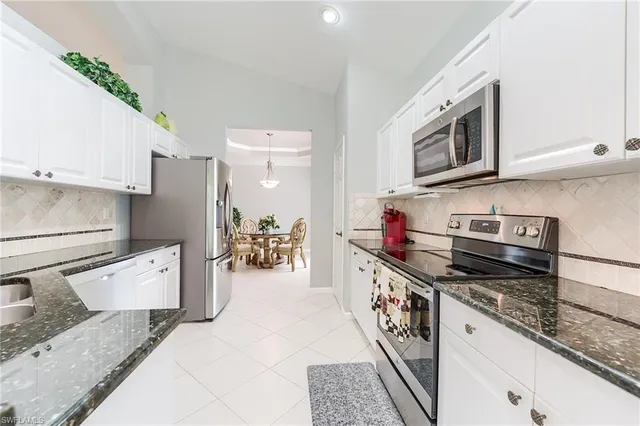 a kitchen with stainless steel appliances granite countertop a stove and a refrigerator