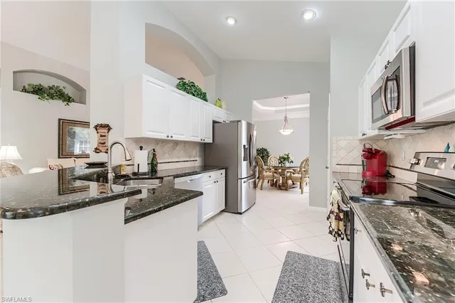 a kitchen with stove and refrigerator