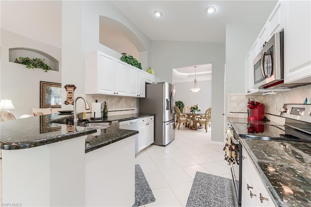 23166 Rosedale Drive, Unit 201 Estero, FL 34135 - Photo 5 of 40 a kitchen with stove and refrigerator