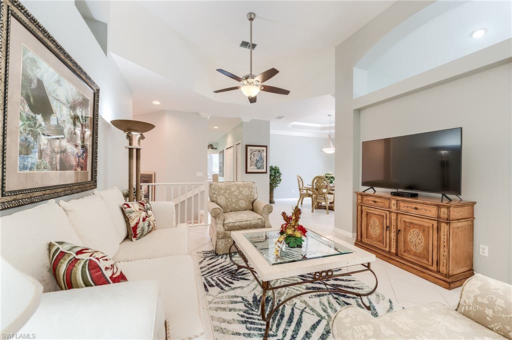 23166 Rosedale Drive, Unit 201 Estero, FL 34135 - Photo 8 of 40 a living room with furniture and a flat screen tv