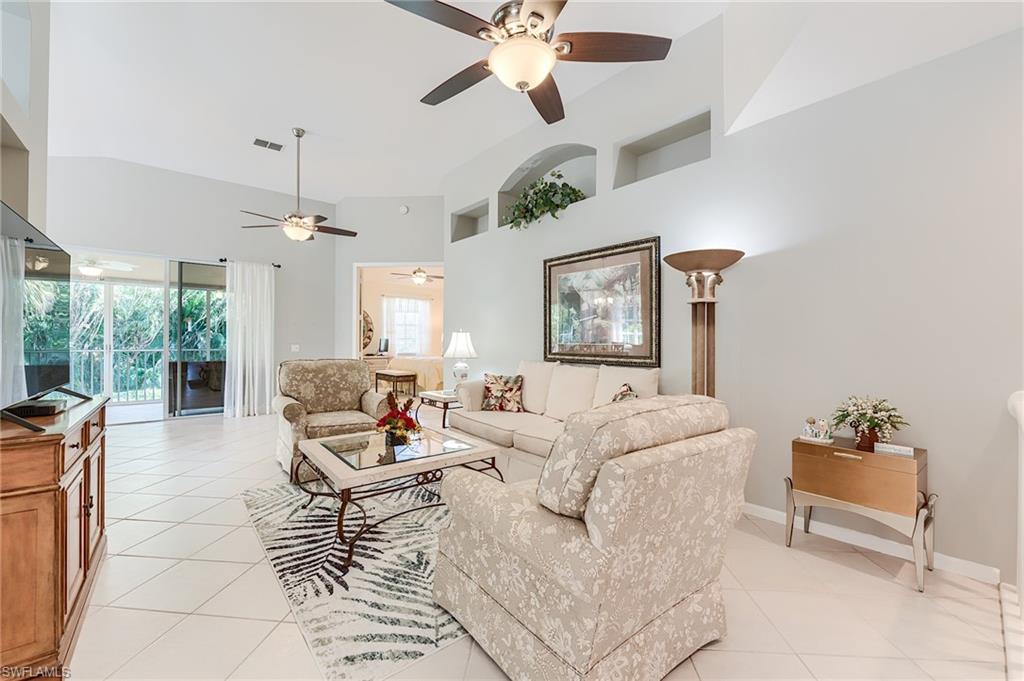 23166 Rosedale Drive, Unit 201 Estero, FL 34135 - Photo 9 of 40 a living room with furniture and a large window