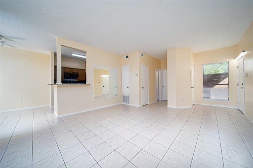 8293 Sands Point Drive, Unit 185 Houston, TX 77036 - Photo 8 of 20 an empty room with a fireplace and natural light
