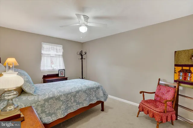 a bedroom with a bed and chair