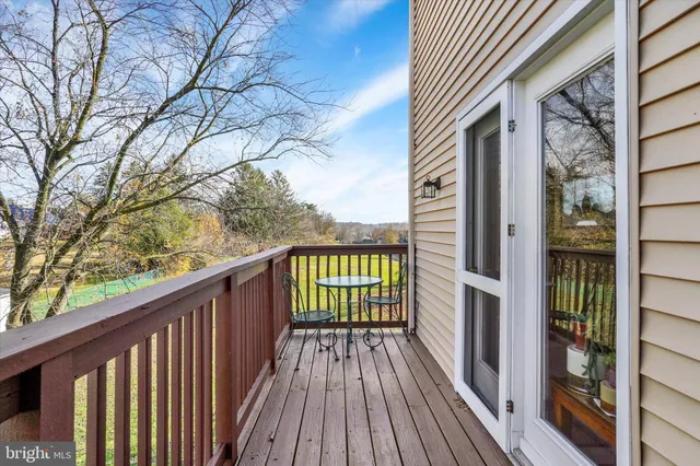 a view of a wooden balcony and trees