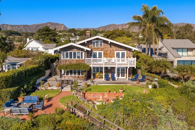an aerial view of a house with a big yard
