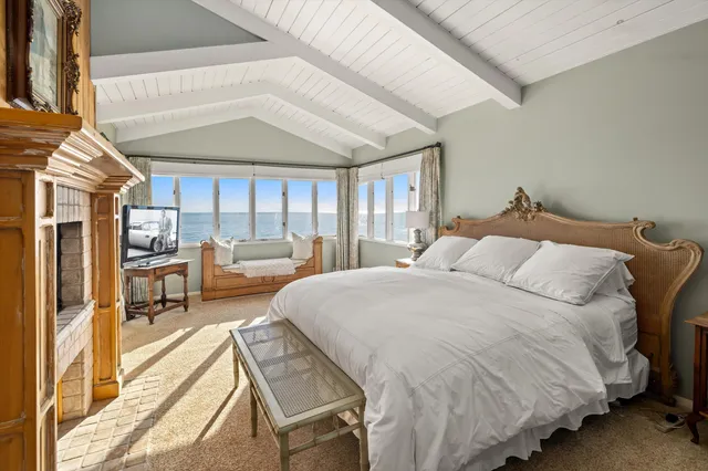 a bed room with a bed and a chair