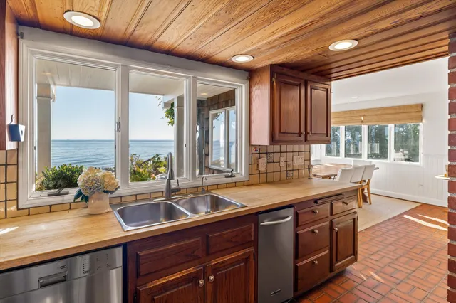 a kitchen with sink and large window