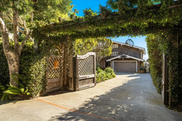 a pathway of a house with wooden fence