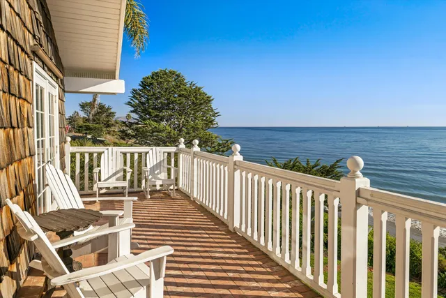 a view of a chairs and table on the balcony