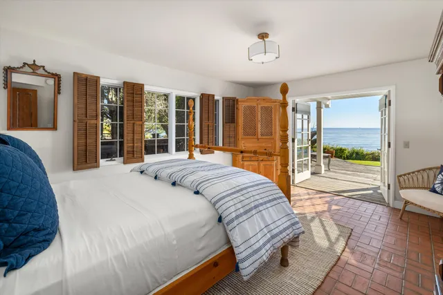 a bedroom with a large bed and a balcony view