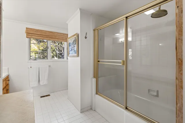 a bathroom with a glass shower door