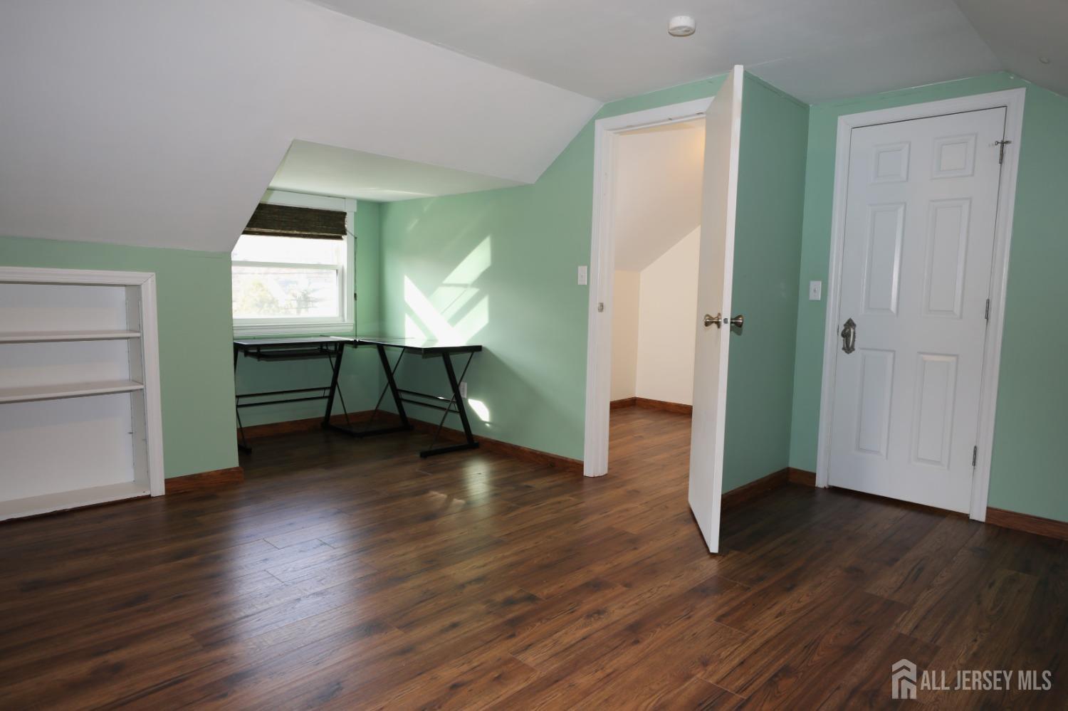 121 Washington Road Princeton, NJ 08540 - Photo 34 of 43 a view of a room with wooden floor staircase and a kitchen