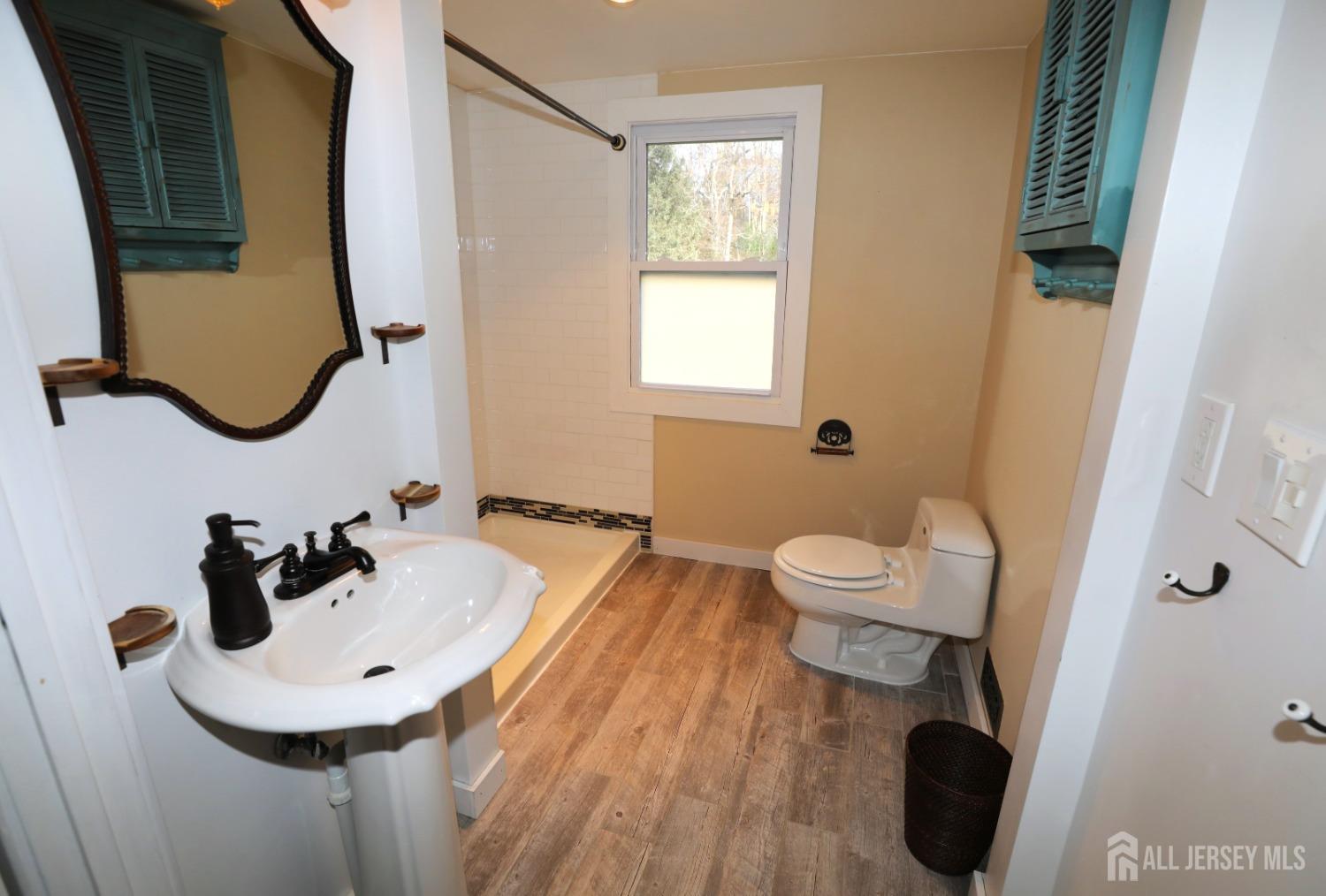 121 Washington Road Princeton, NJ 08540 - Photo 36 of 43 a bathroom with a sink and mirror with toilet