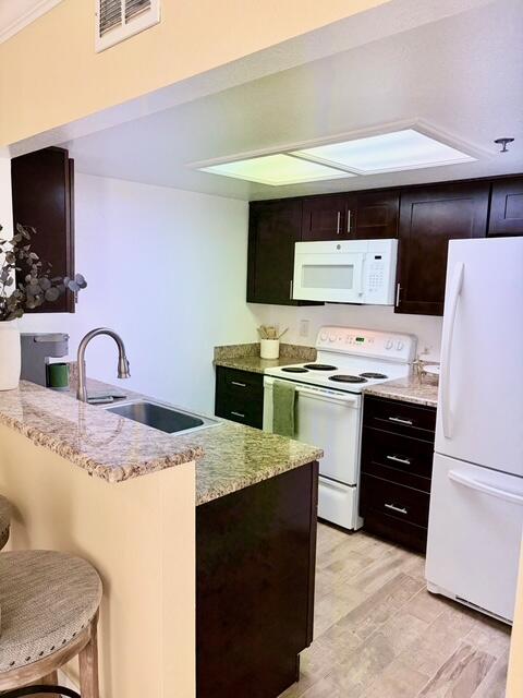 43376 Cook Street, Unit 87 Palm Desert, CA 92211 - Photo 14 of 35 a kitchen with kitchen island a sink appliances and cabinets