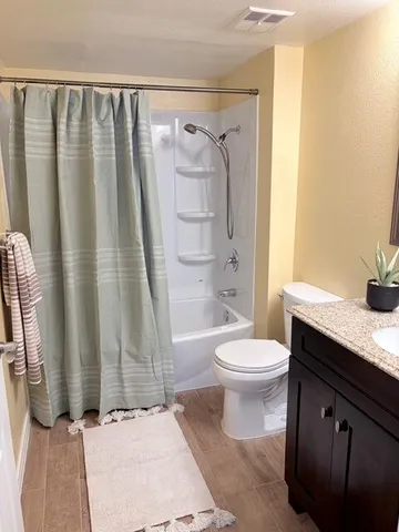 a bathroom with a toilet a sink and shower