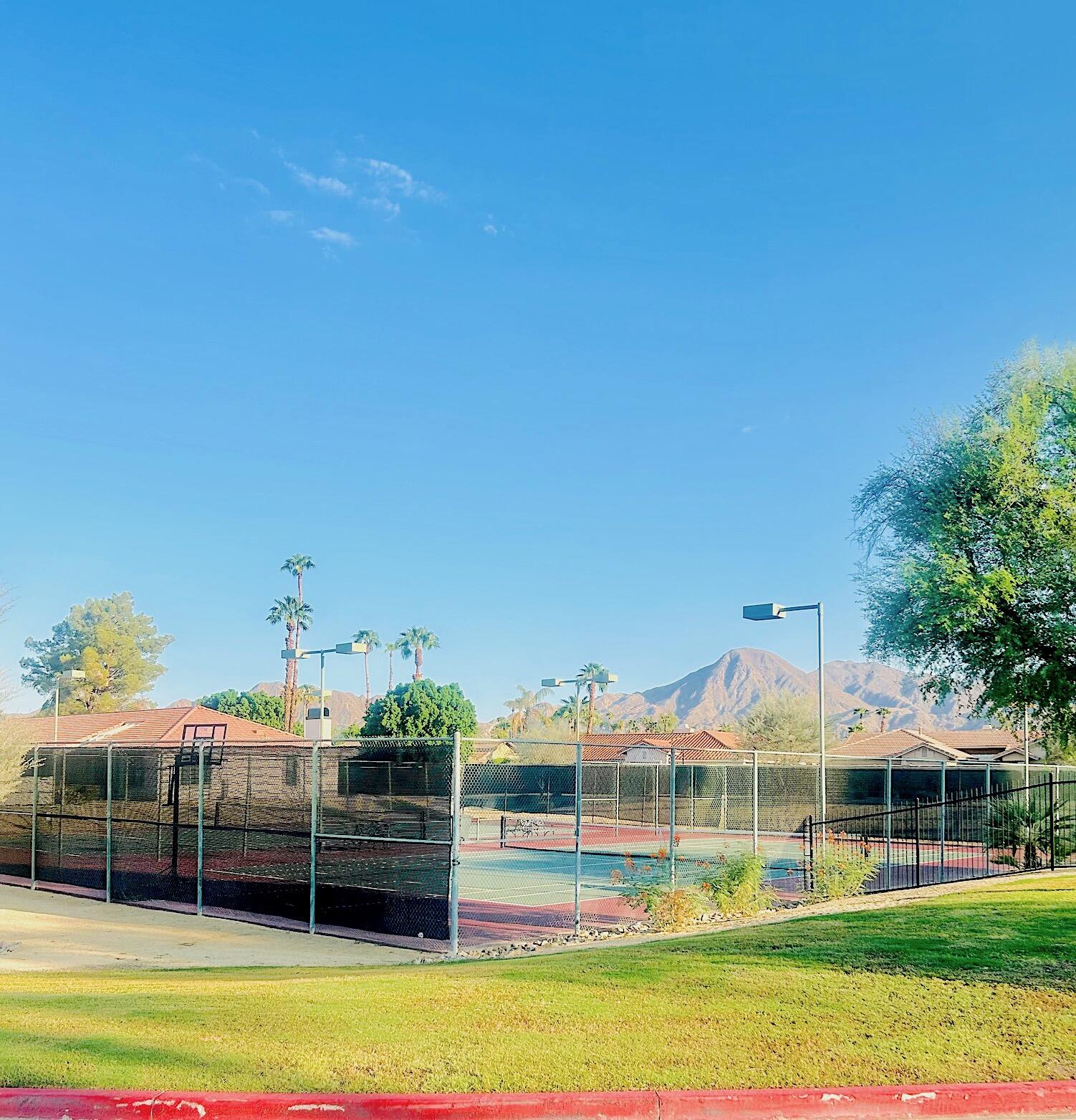 43376 Cook Street, Unit 87 Palm Desert, CA 92211 - Photo 29 of 35 a view of a large building with a big yard and plants