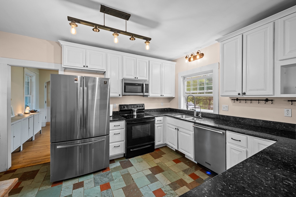 10 Maple Street Sturbridge, MA 01566 - Photo 14 of 40 a kitchen with granite countertop a refrigerator and a sink