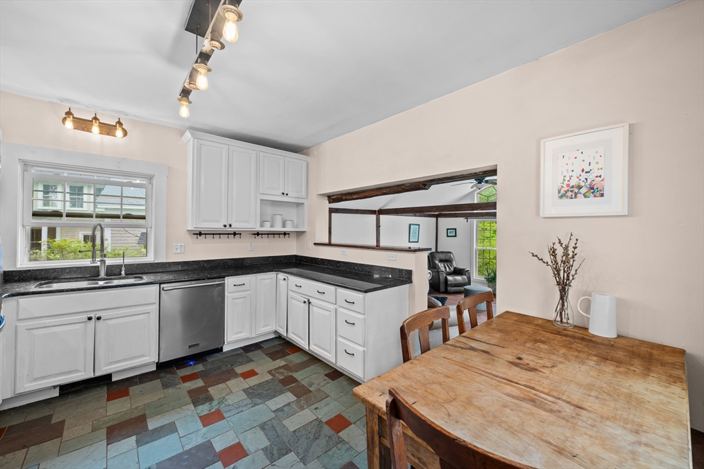 10 Maple Street Sturbridge, MA 01566 - Photo 16 of 40 a kitchen with granite countertop a sink stove and cabinets