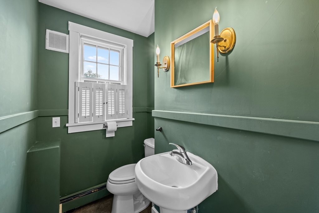 10 Maple Street Sturbridge, MA 01566 - Photo 20 of 40 a bathroom with a toilet sink and mirror