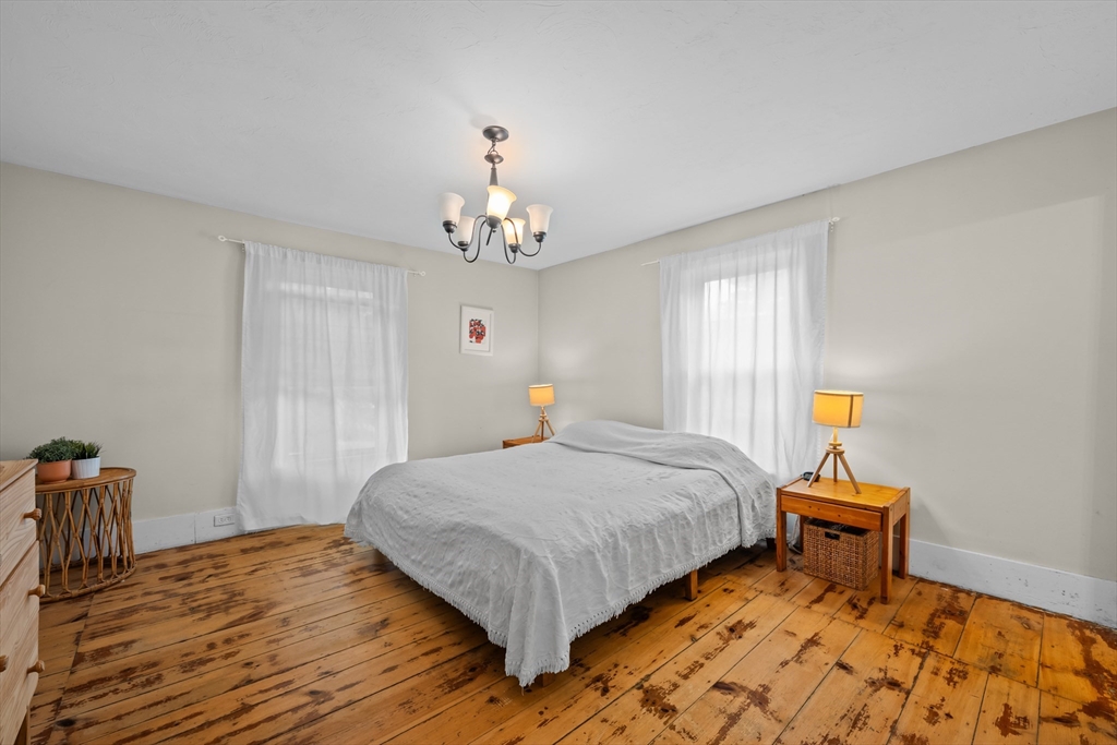 10 Maple Street Sturbridge, MA 01566 - Photo 23 of 40 a bedroom with a bed and wooden floor