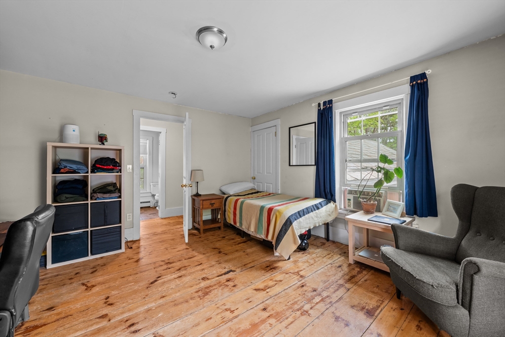 10 Maple Street Sturbridge, MA 01566 - Photo 28 of 40 a bedroom with a bed a couch and a window