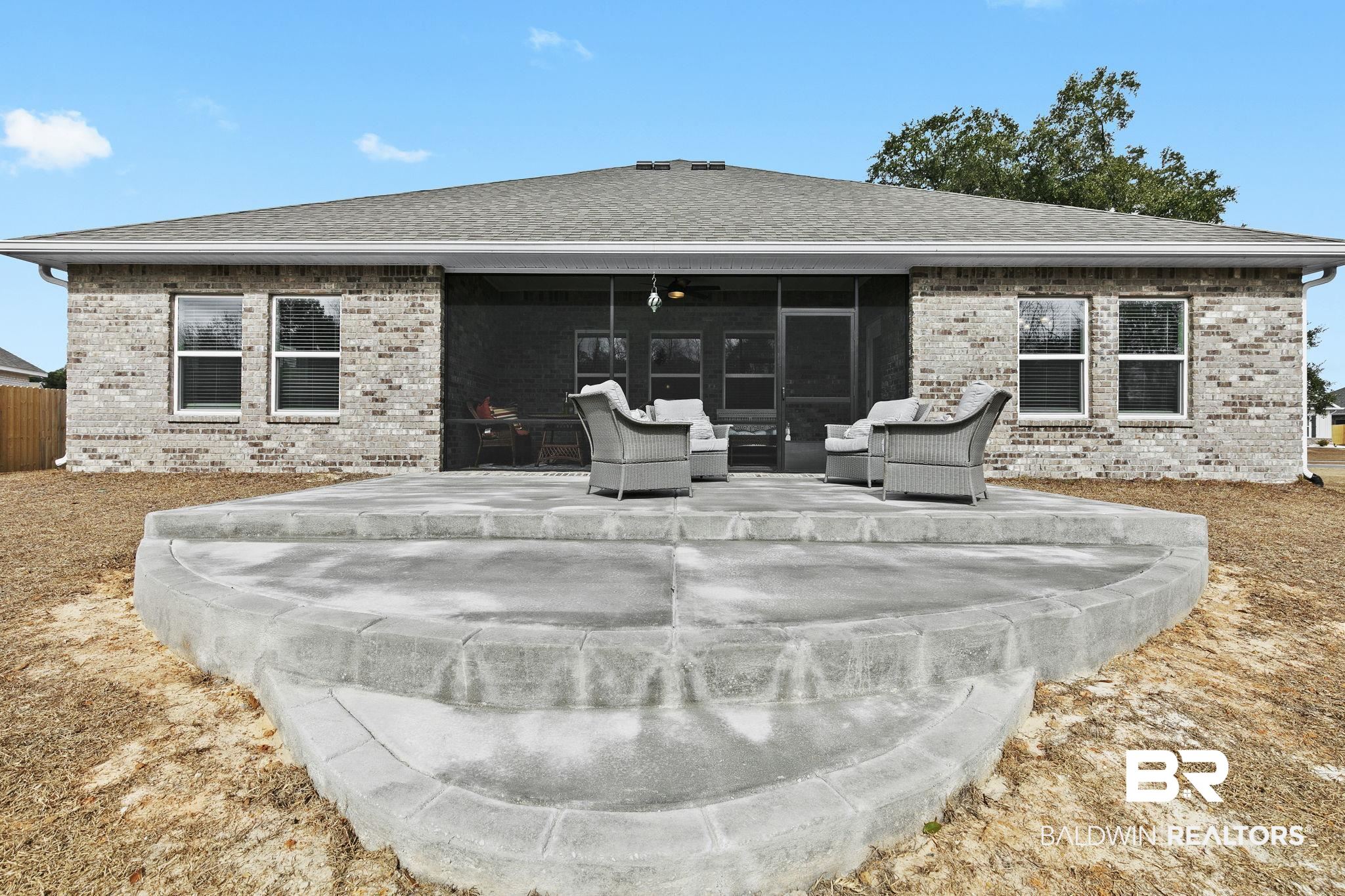 1141 Pencarro Boulevard Foley, AL 36535 - Photo 59 of 70 Rear view of house featuring a sunroom, an outdoor hangout area, and a patio area